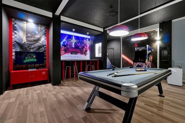 playroom featuring wood-type flooring, a textured ceiling, and pool table