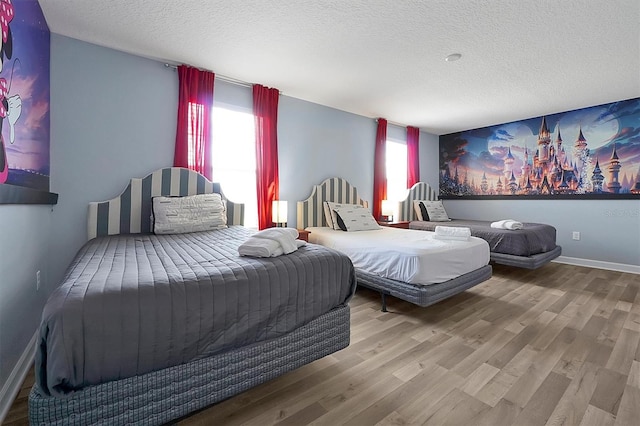 bedroom featuring hardwood / wood-style floors and a textured ceiling