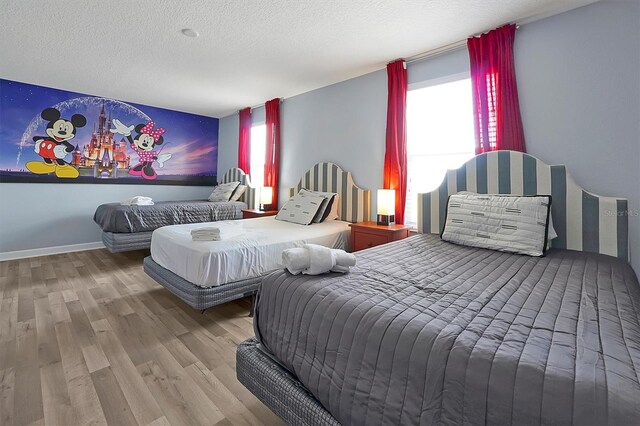 bedroom featuring a textured ceiling and hardwood / wood-style flooring