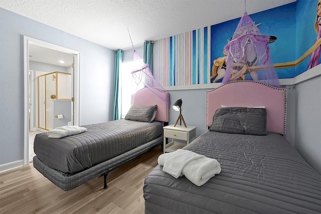 bedroom featuring a textured ceiling and hardwood / wood-style flooring