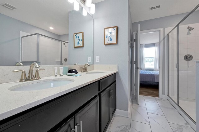 bathroom featuring vanity and an enclosed shower