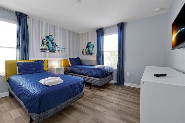 bedroom featuring hardwood / wood-style floors and a textured ceiling