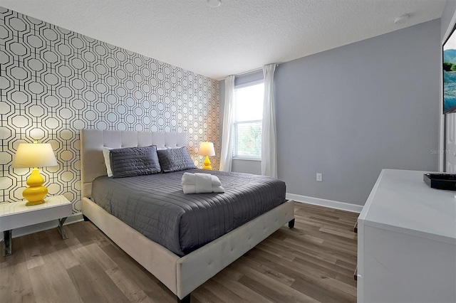 bedroom with hardwood / wood-style flooring and a textured ceiling