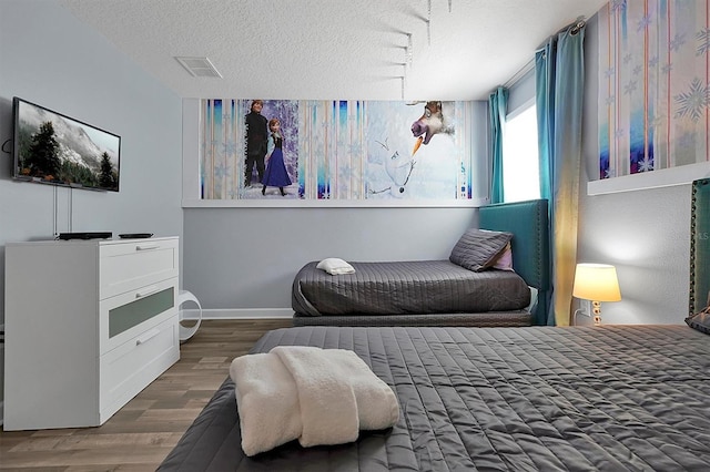 bedroom featuring a textured ceiling and dark wood-type flooring