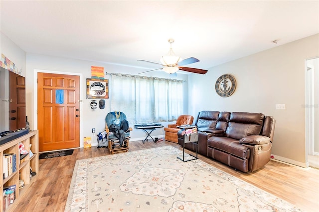 living room featuring hardwood / wood-style floors and ceiling fan