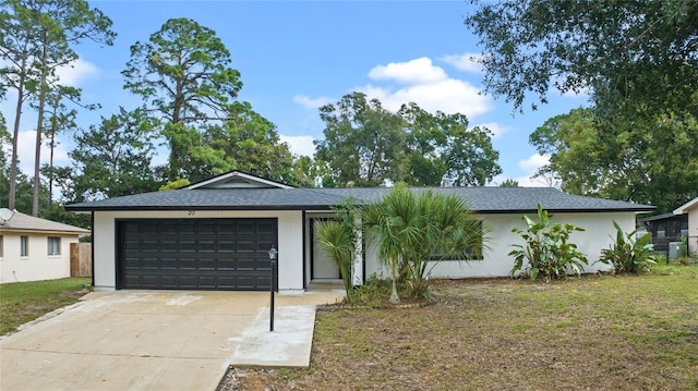 ranch-style house with a front yard and a garage