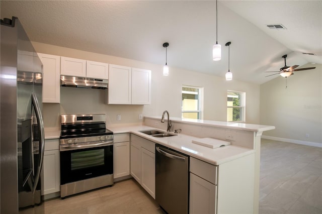 kitchen featuring white cabinetry, stainless steel appliances, kitchen peninsula, pendant lighting, and vaulted ceiling