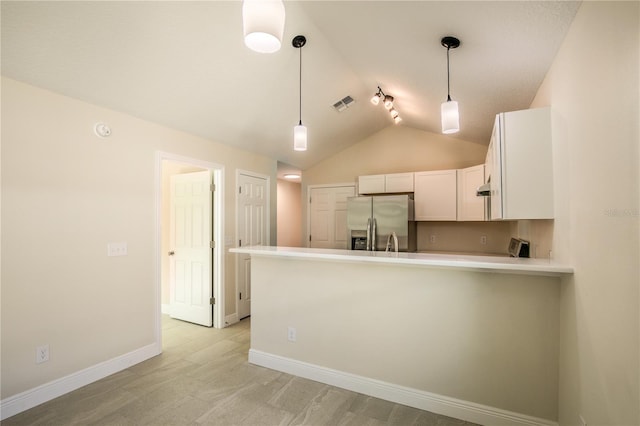 kitchen with kitchen peninsula, rail lighting, stainless steel fridge with ice dispenser, white cabinetry, and lofted ceiling