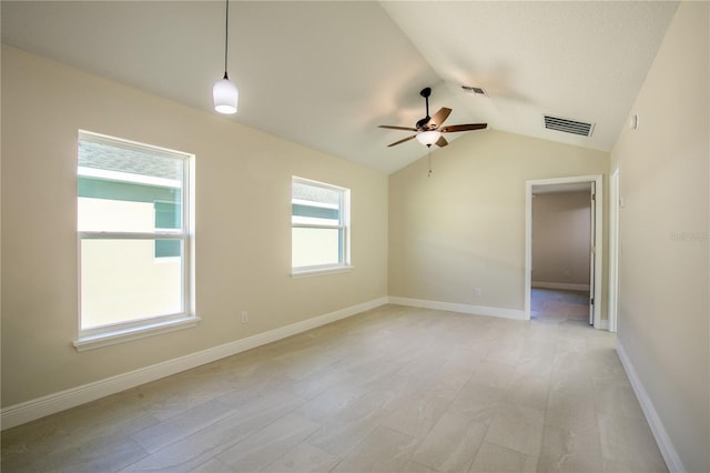 empty room with ceiling fan, vaulted ceiling, and light wood-type flooring