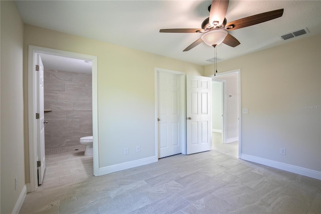 unfurnished bedroom with ceiling fan and ensuite bath