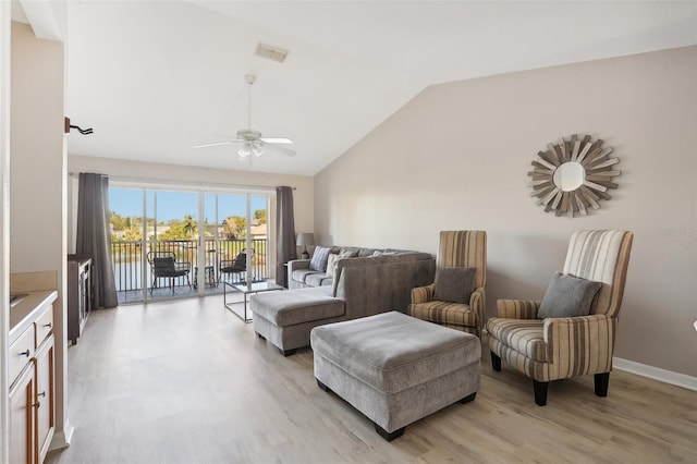 living room featuring light hardwood / wood-style flooring, ceiling fan, and lofted ceiling