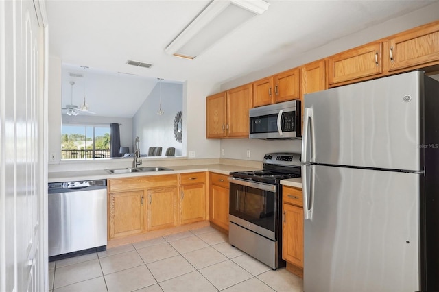 kitchen with appliances with stainless steel finishes, ceiling fan, sink, light tile patterned floors, and lofted ceiling