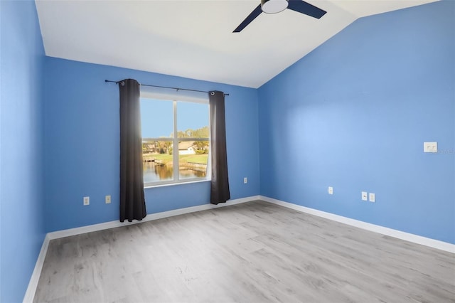 empty room with light wood-type flooring, vaulted ceiling, and ceiling fan