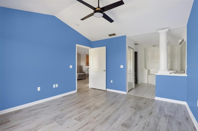 unfurnished bedroom featuring connected bathroom, ceiling fan, light hardwood / wood-style flooring, and vaulted ceiling