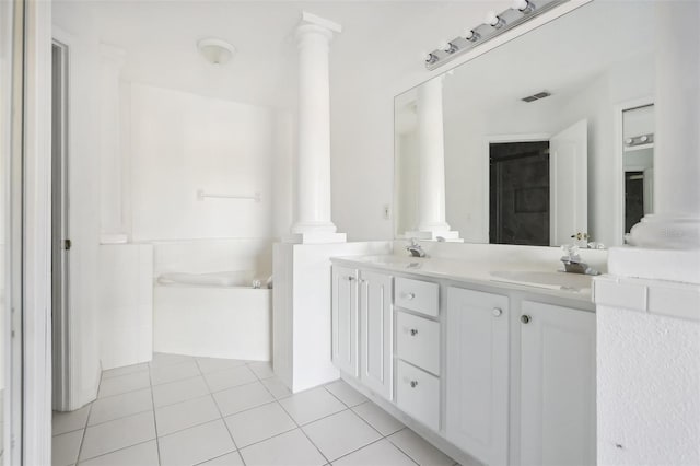 bathroom featuring tile patterned flooring, a washtub, and vanity