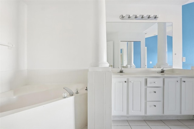 bathroom featuring a bathing tub, tile patterned flooring, and vanity