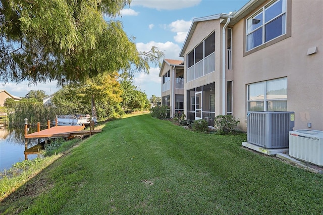 view of yard featuring a water view and central AC