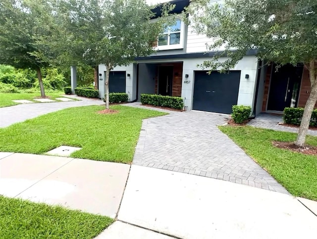 view of front of property with a front yard and a garage