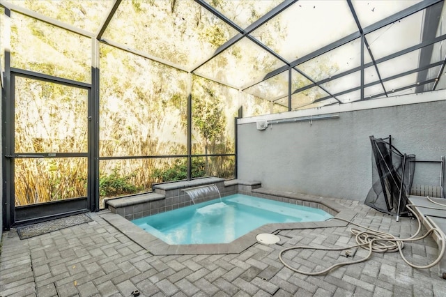 view of swimming pool with an in ground hot tub, a patio, and a lanai