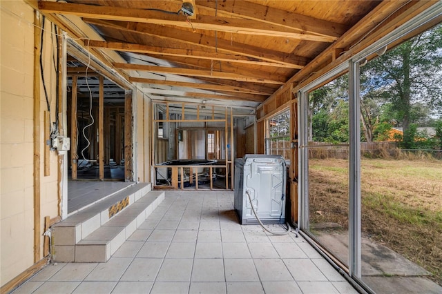 unfurnished sunroom featuring vaulted ceiling