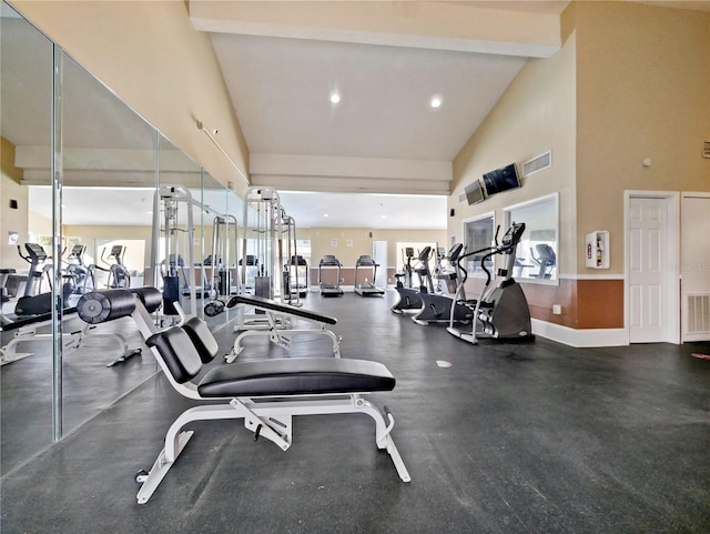 workout area featuring high vaulted ceiling