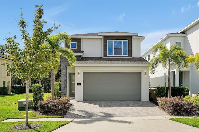 view of front of property featuring a garage and a front lawn