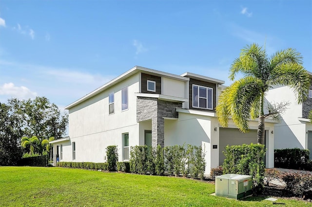 view of side of home with a garage and a yard