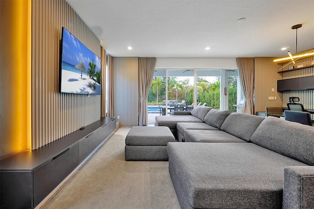 carpeted living room with a textured ceiling and a chandelier