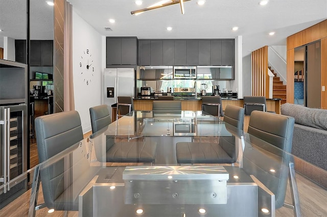 dining space featuring light hardwood / wood-style floors and a textured ceiling