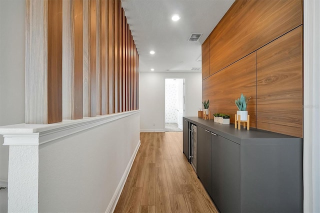 corridor with light hardwood / wood-style flooring