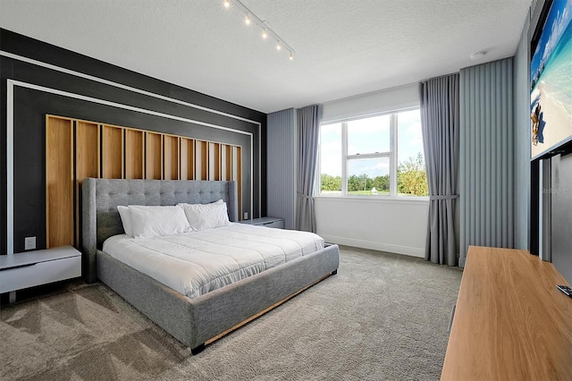 carpeted bedroom featuring a textured ceiling