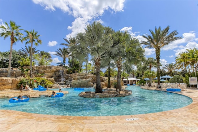 view of swimming pool with pool water feature