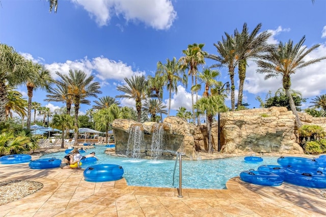 view of swimming pool with pool water feature