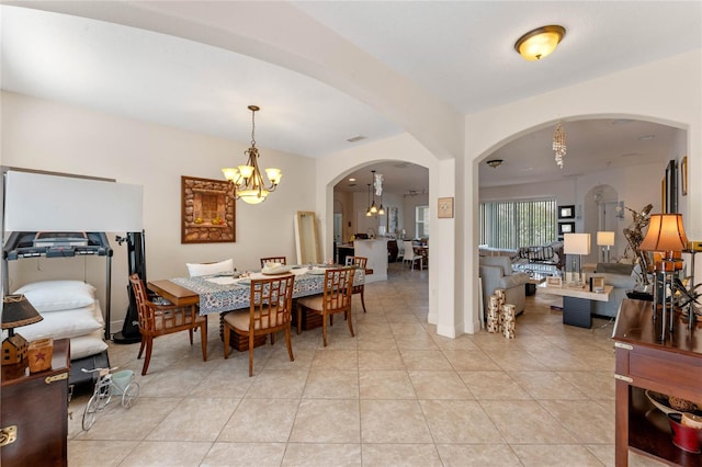 tiled dining space featuring a chandelier