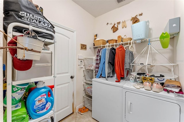 laundry room with light tile patterned flooring and washing machine and clothes dryer