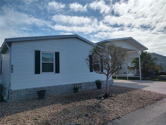 view of side of home with a carport