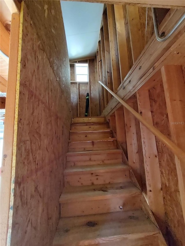 staircase featuring lofted ceiling