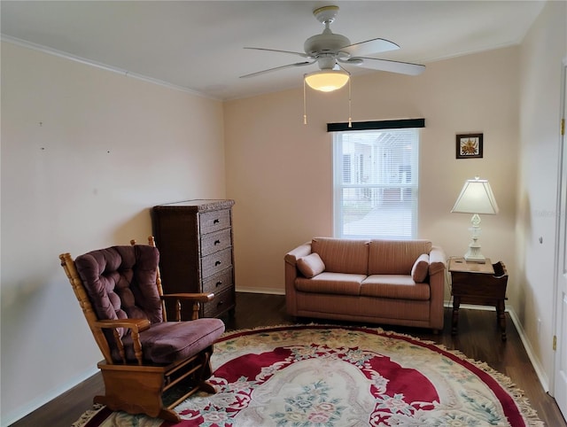 living room featuring ceiling fan, dark wood-type flooring, and ornamental molding