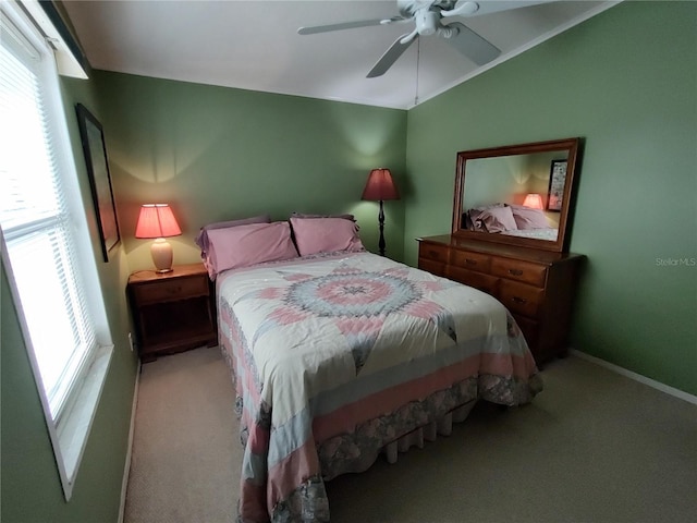 carpeted bedroom featuring ceiling fan and lofted ceiling