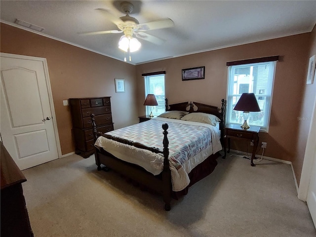 carpeted bedroom featuring ceiling fan and ornamental molding