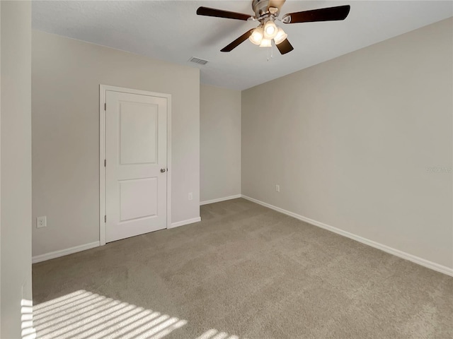 unfurnished room with ceiling fan and light colored carpet