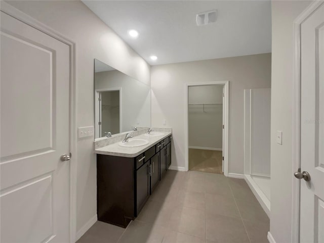 127 Hickory Crse, Ocala, FL 34472 - full bath with a spacious closet, double vanity, tile patterned flooring, baseboards, and recessed lighting