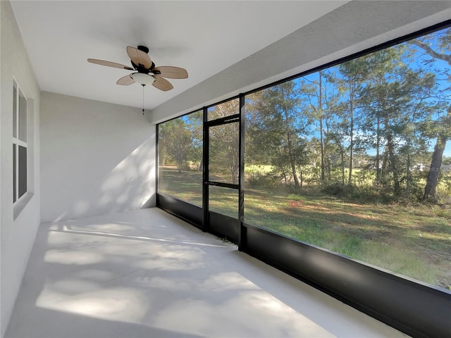 unfurnished sunroom featuring ceiling fan