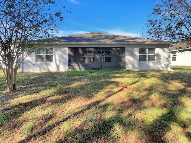 rear view of property featuring a yard