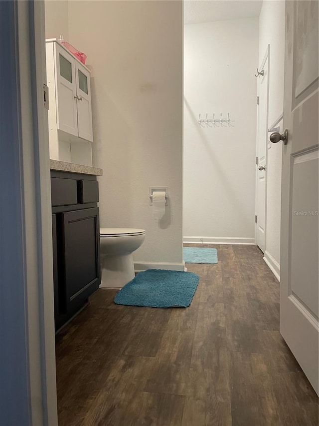 bathroom featuring hardwood / wood-style floors, vanity, and toilet