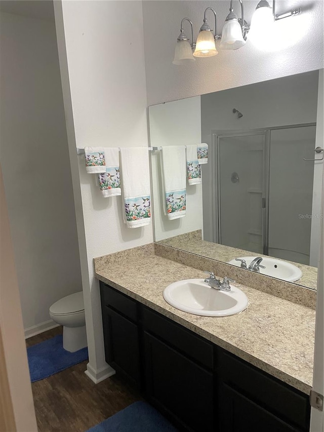 bathroom featuring hardwood / wood-style flooring, vanity, and toilet