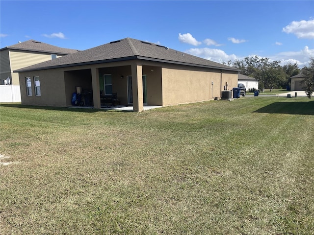 view of side of property featuring a lawn and a patio area