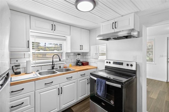 kitchen featuring decorative backsplash, appliances with stainless steel finishes, sink, white cabinets, and dark hardwood / wood-style floors