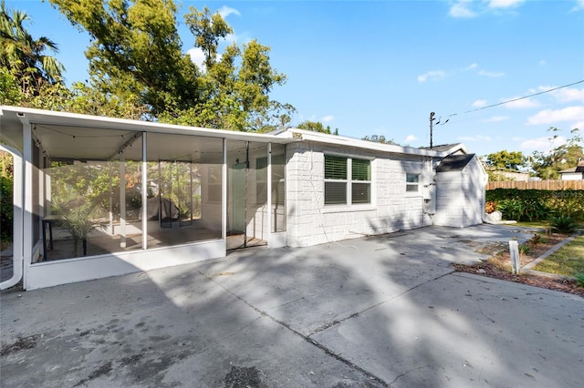 back of house with a sunroom and a patio area