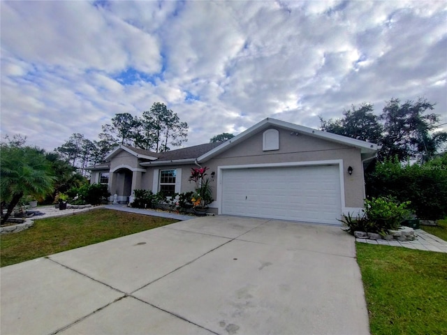 ranch-style home with stucco siding, a front lawn, an attached garage, and driveway